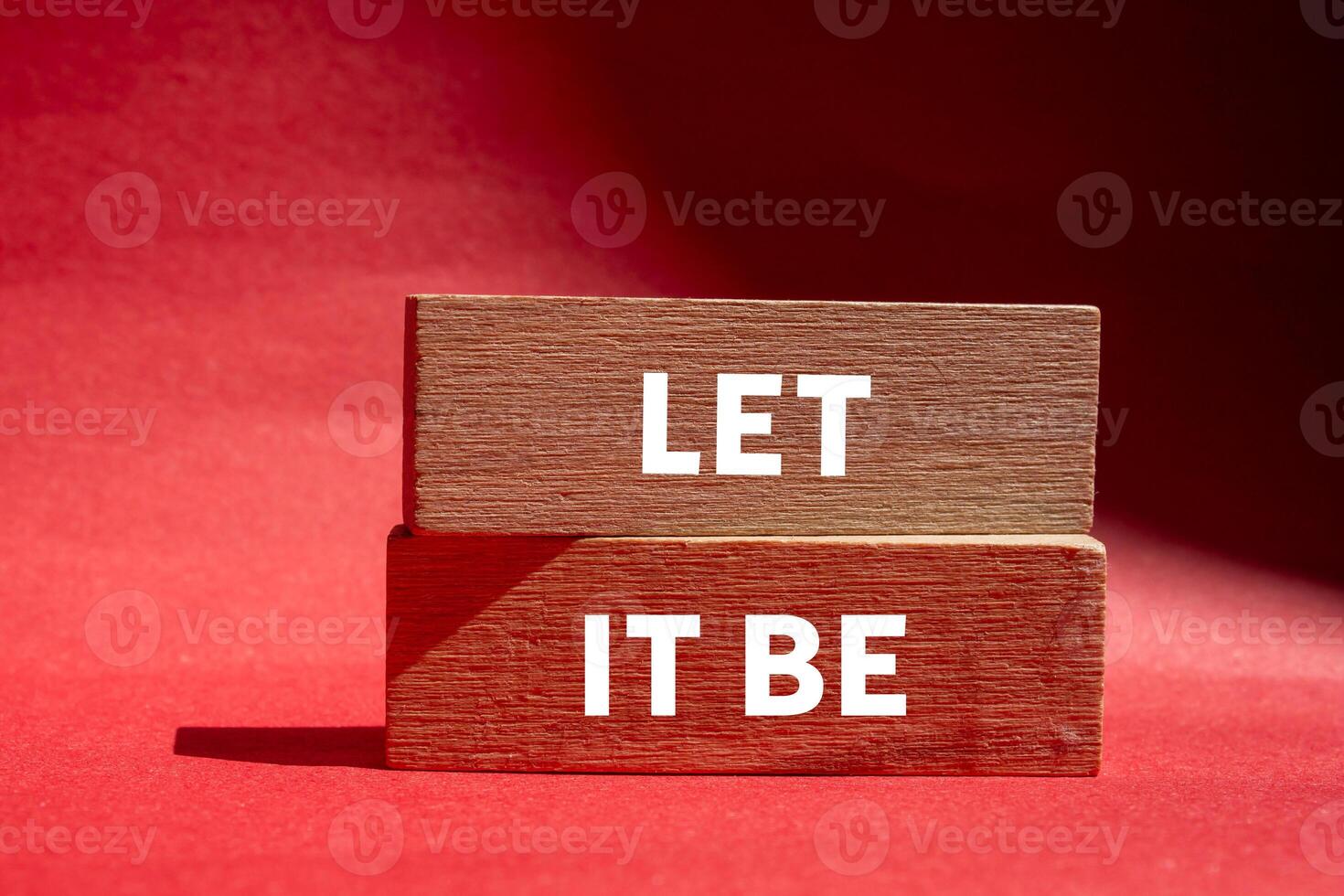 Let it be message written on wooden blocks on red background. Conceptual let it be symbol. Copy space. photo