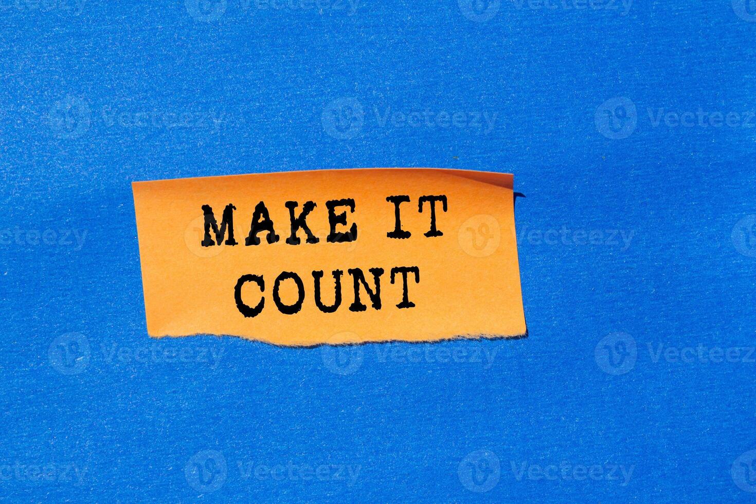 Make it count message written on ripped torn orange paper on blue background. Conceptual make it count symbol. Copy space. photo