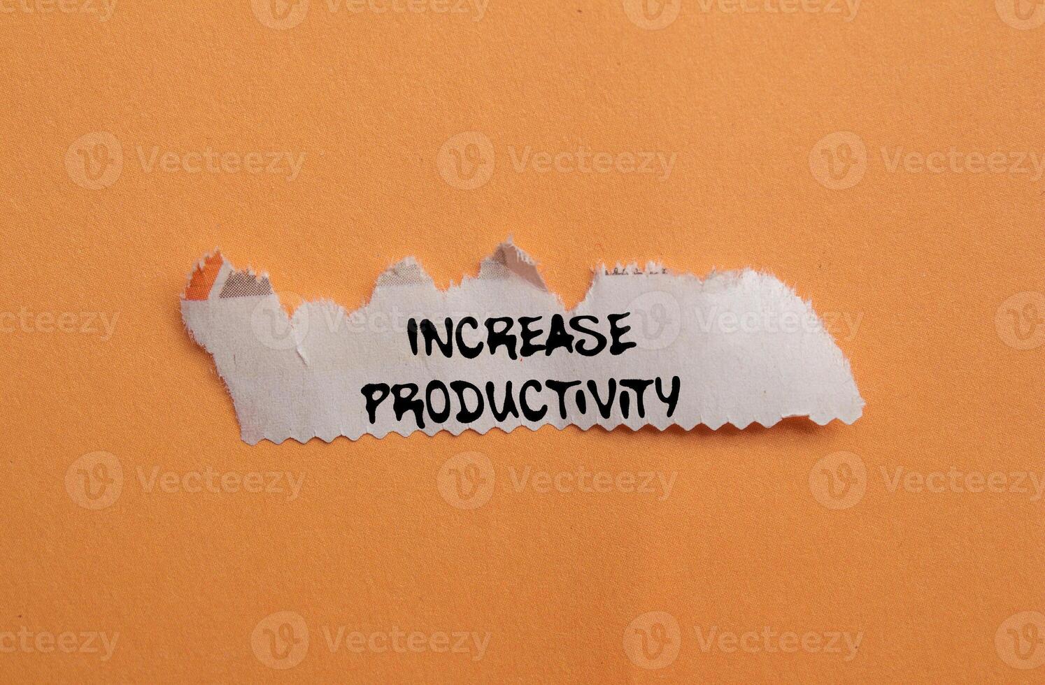 Increase productivity message written on ripped torn newspaper piece on orange background. Conceptual increase productivity symbol. Copy space. photo
