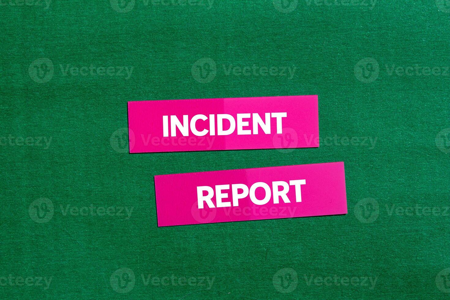 Incident report message written on pink stickers on green background. Conceptual incident report symbol. Copy space. photo