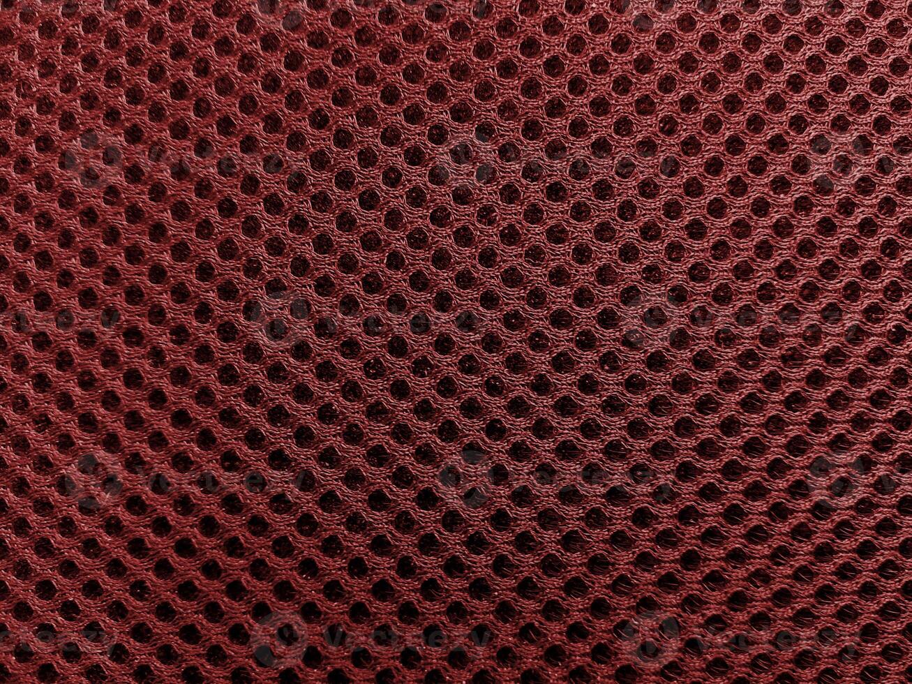 Circular Red Holes Febric Texture Background photo