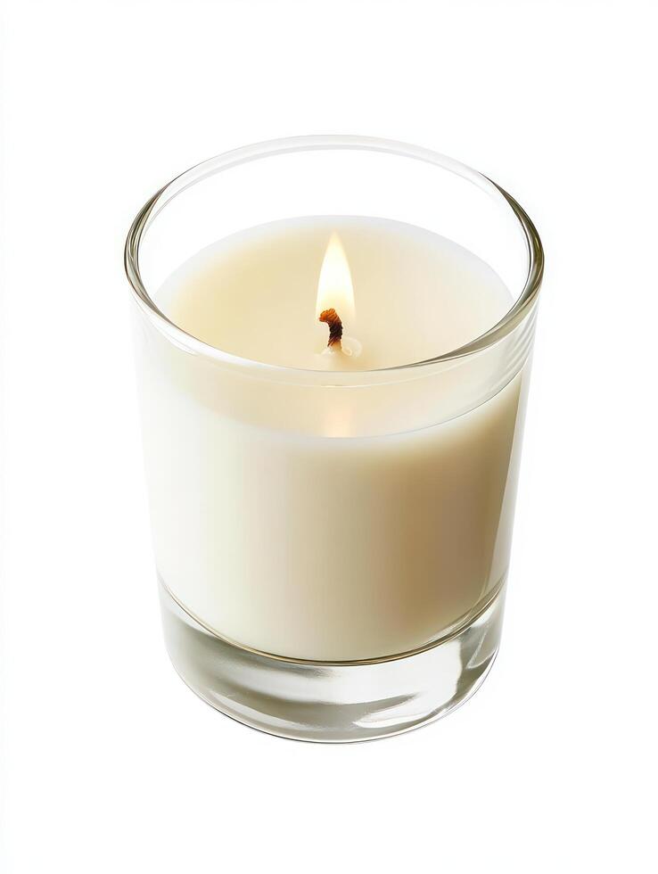 A candle is shown in a glass container photo