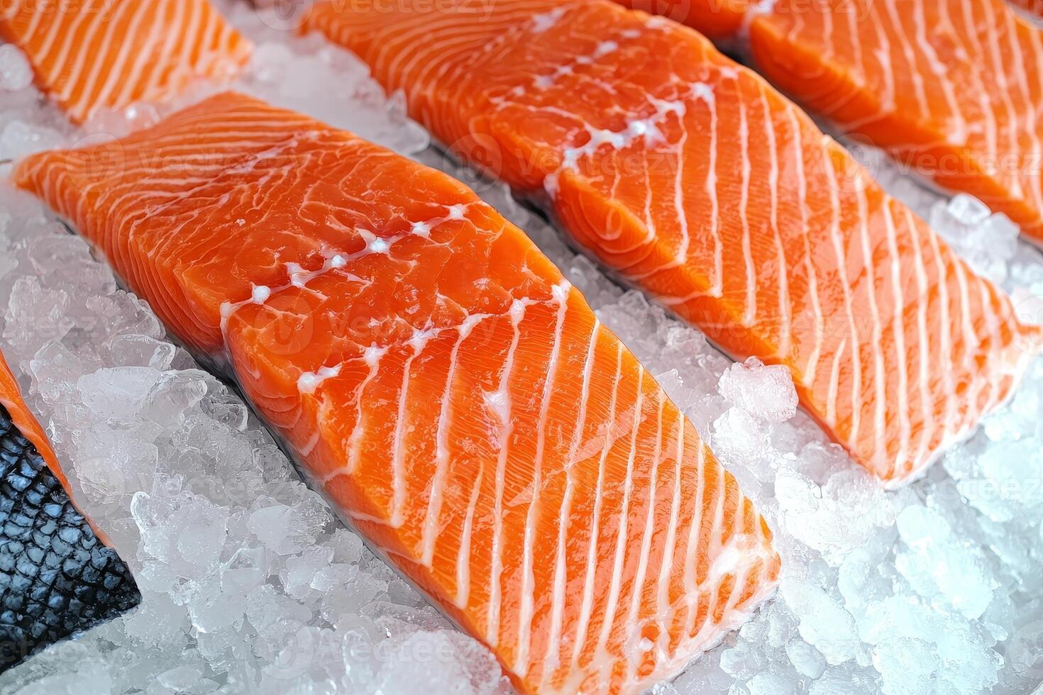 Fresh salmon fillets on ice, showcasing vibrant orange color and distinct marbling, ready for culinary preparation or display. photo