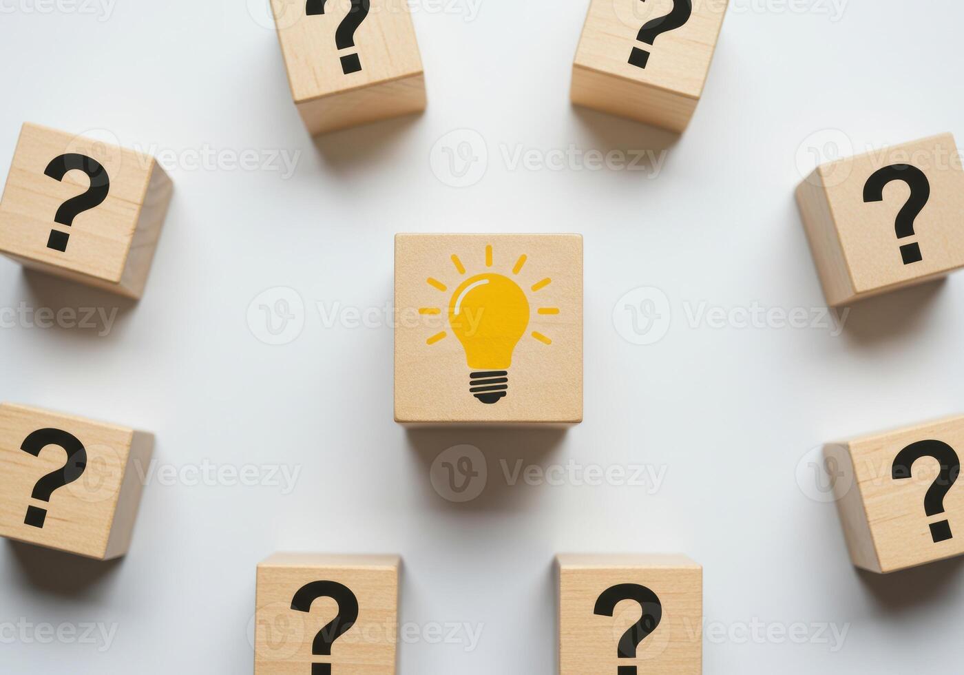 Wooden Block with Lightbulb Surrounded by Question Marks Representing New Ideas and Solutions photo