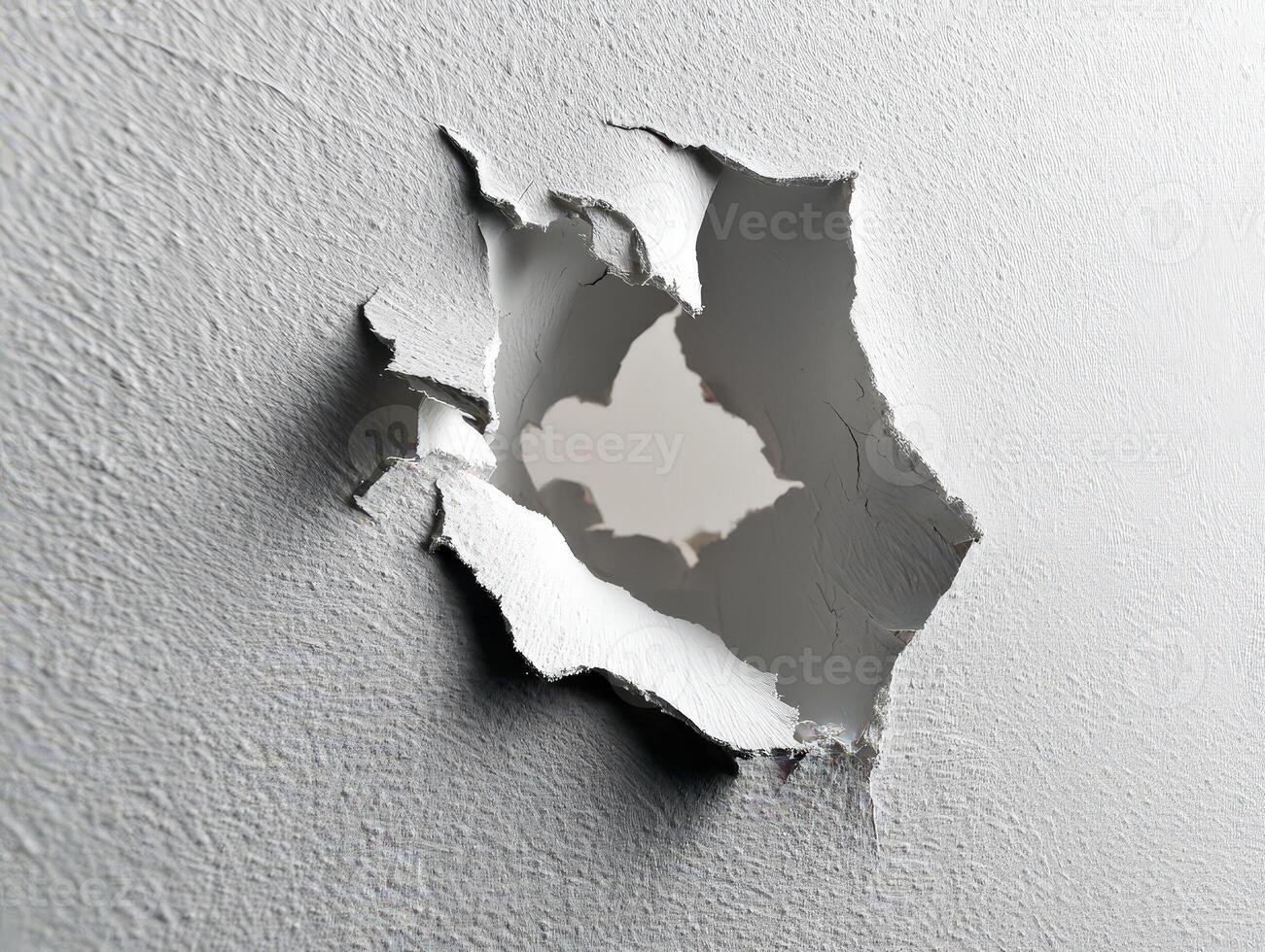 A textured wall with a large, jagged hole in the center, revealing another rough surface beyond it. The torn edges of the wall show layers of material breaking apart photo
