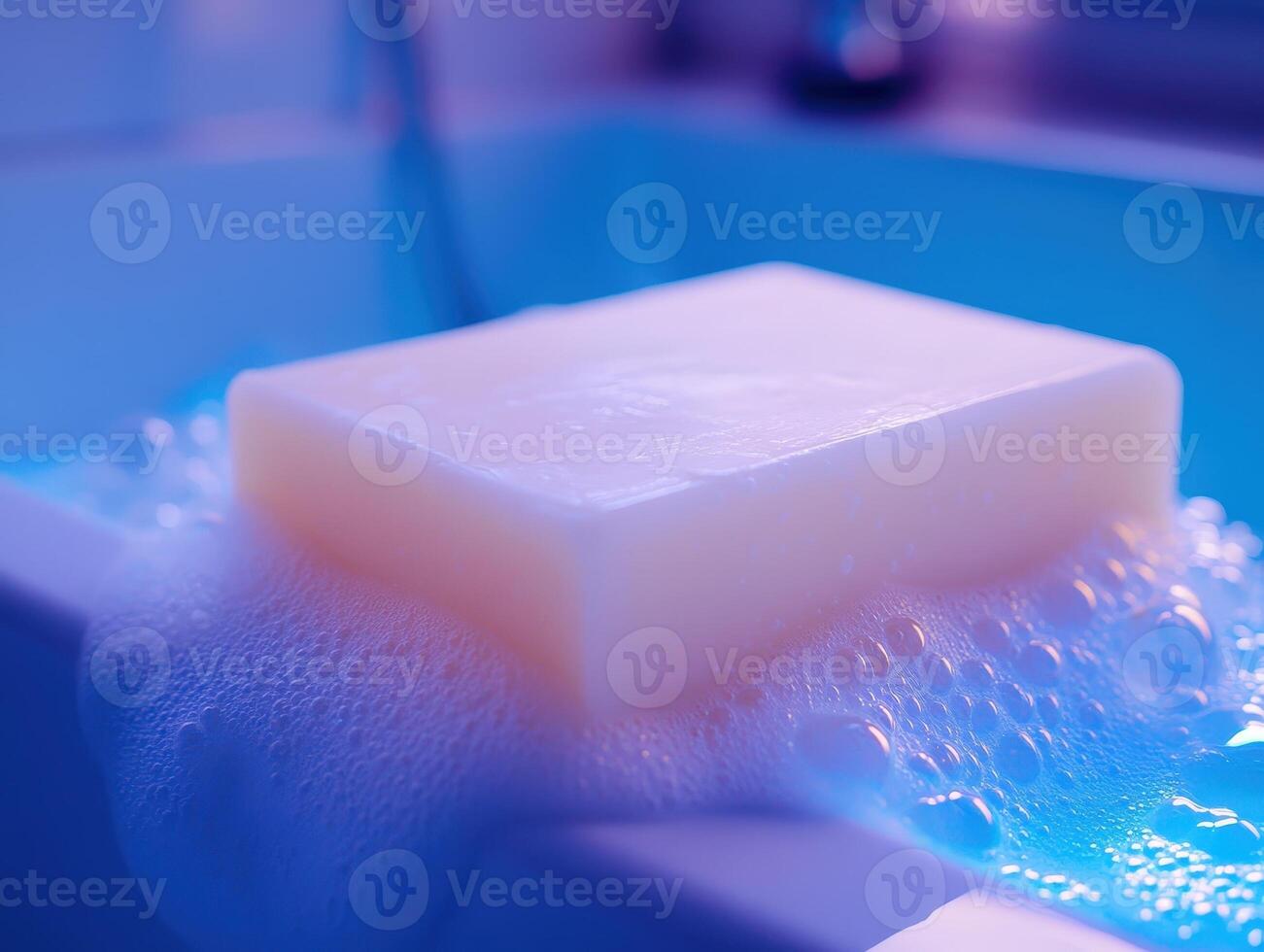 Bar of creamy white soap with luscious foam and bubbles, resting on the edge of a bathtub. Soft lighting with a gentle blue hue, creating a calm and soothing effect photo