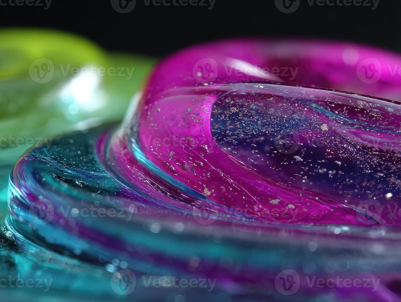 Abstract image featuring close-up view of swirling glossy textures in vibrant pink, blue, and green hues, interspersed with sparkling gold flecks. Focus on fluid and dynamic shapes photo