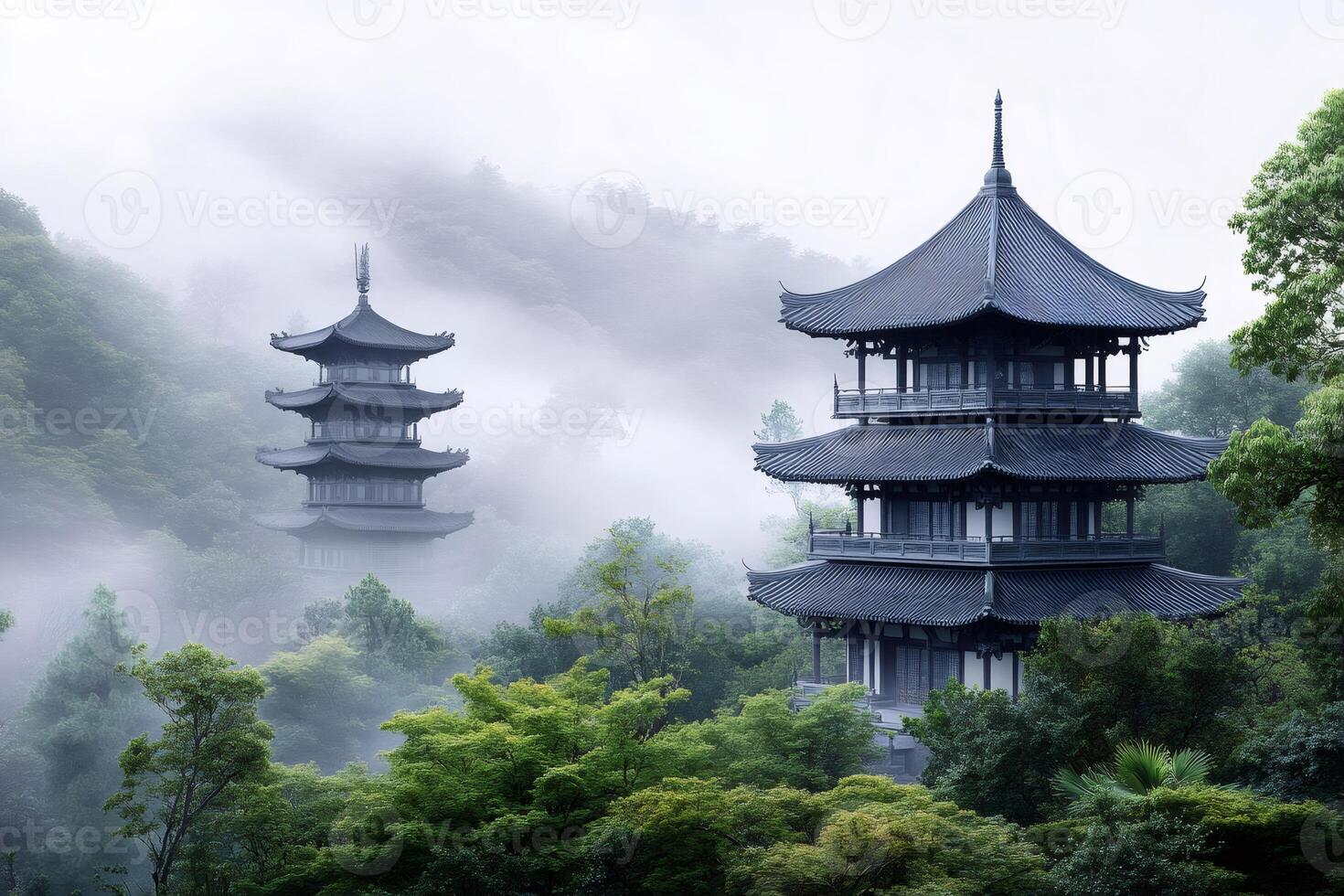 Fog surrounding traditional chinese pagodas in a misty forest landscape photo