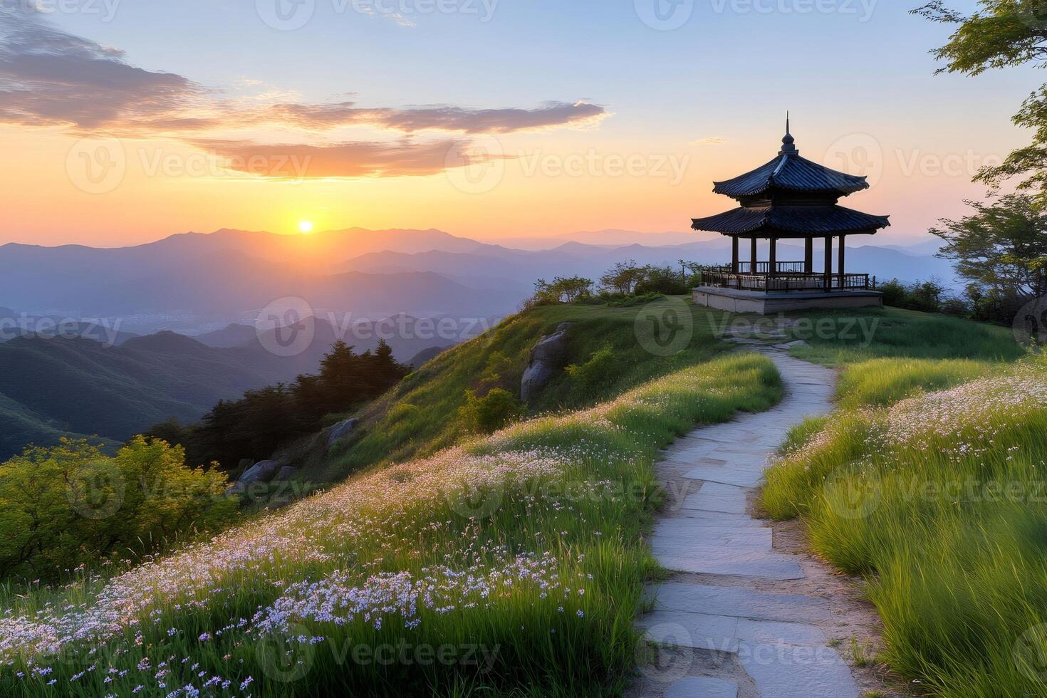 Sun rising over mountains with korean gazebo and flowers photo