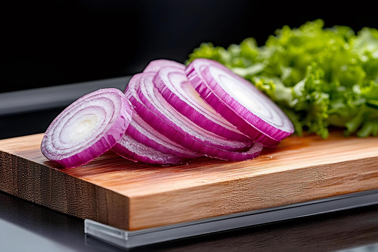 Sliced Red Onion on Wooden Cutting Board with Lettuce photo