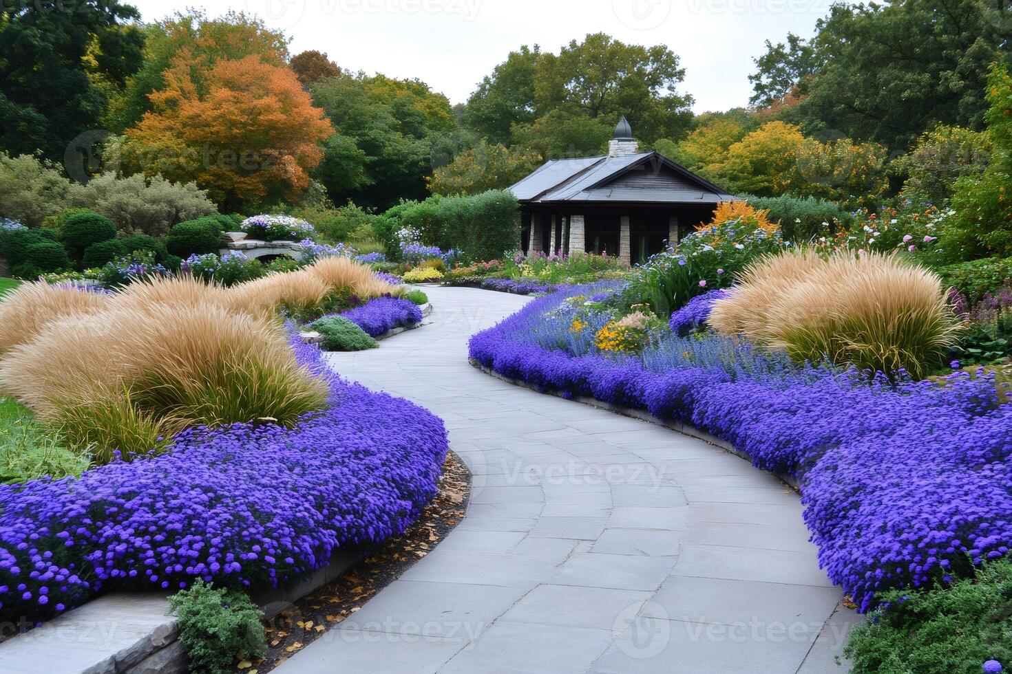 Winding path with purple flowers leading to wooden pavilion in autumn botanical garden photo