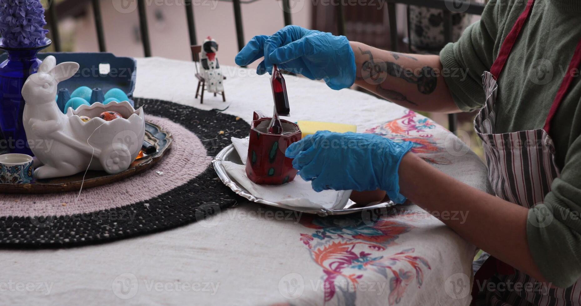 Coloring Easter eggs in vibrant hues during a joyful celebration of the holiday, featuring red egg painting as part of family traditions and creative activities photo