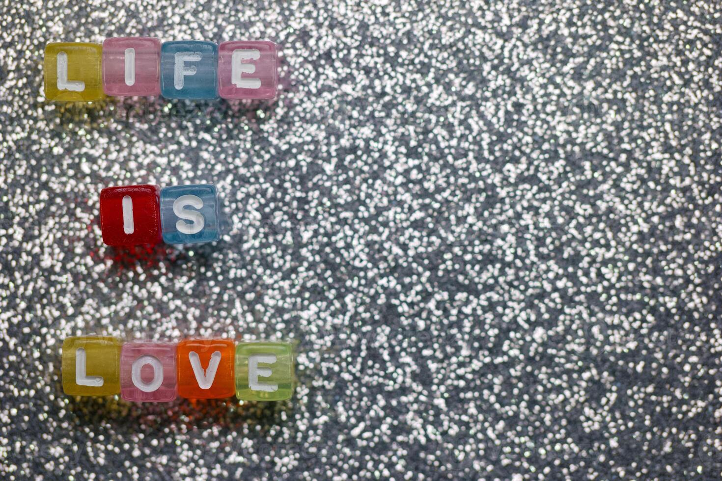 Colorful letters spell out meaningful words on a sparkling background for a creative artistic display photo