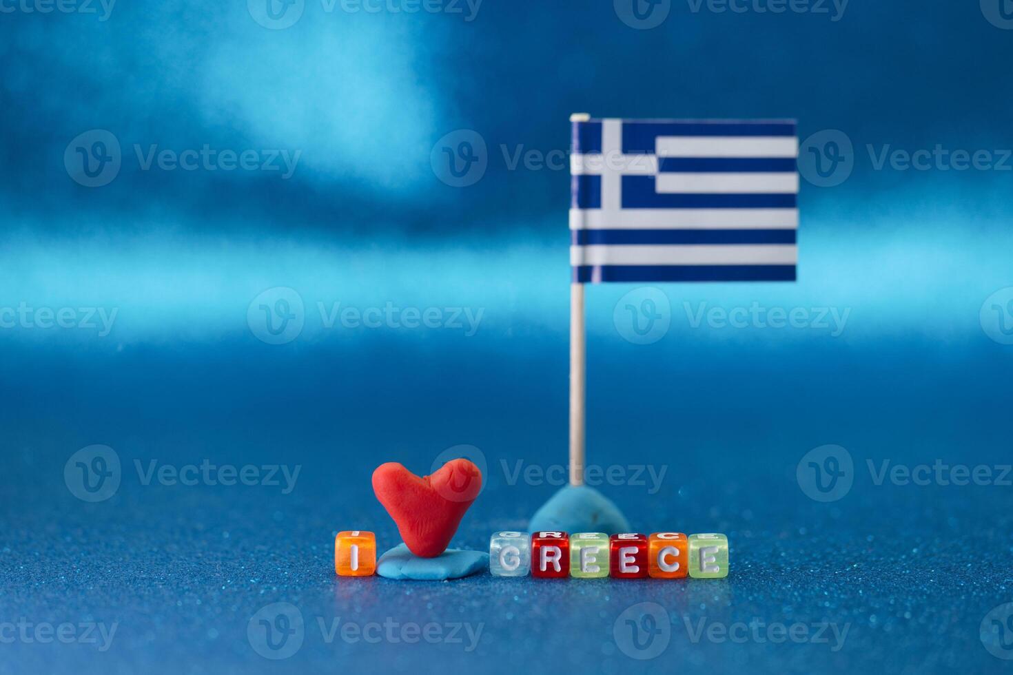 Heart and flag display expressing love for Greece on a bright blue background photo