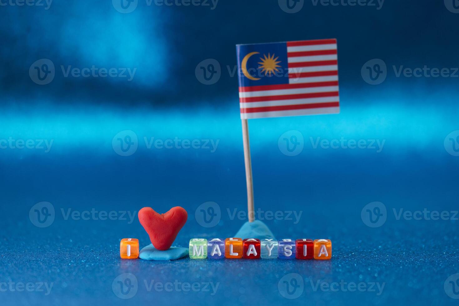 Creative display of love for Malaysia with colorful letters and a flag on a blue background photo