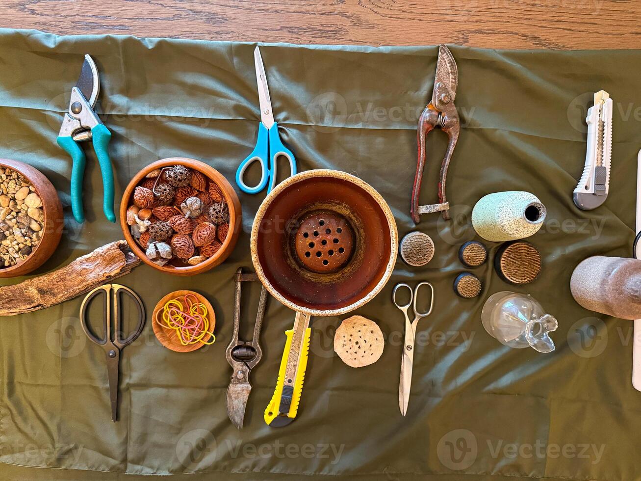 Tools and elements for ikebana floral design arranged on a green cloth. Preparation, creativity, and harmony in Japanese flower arrangement photo