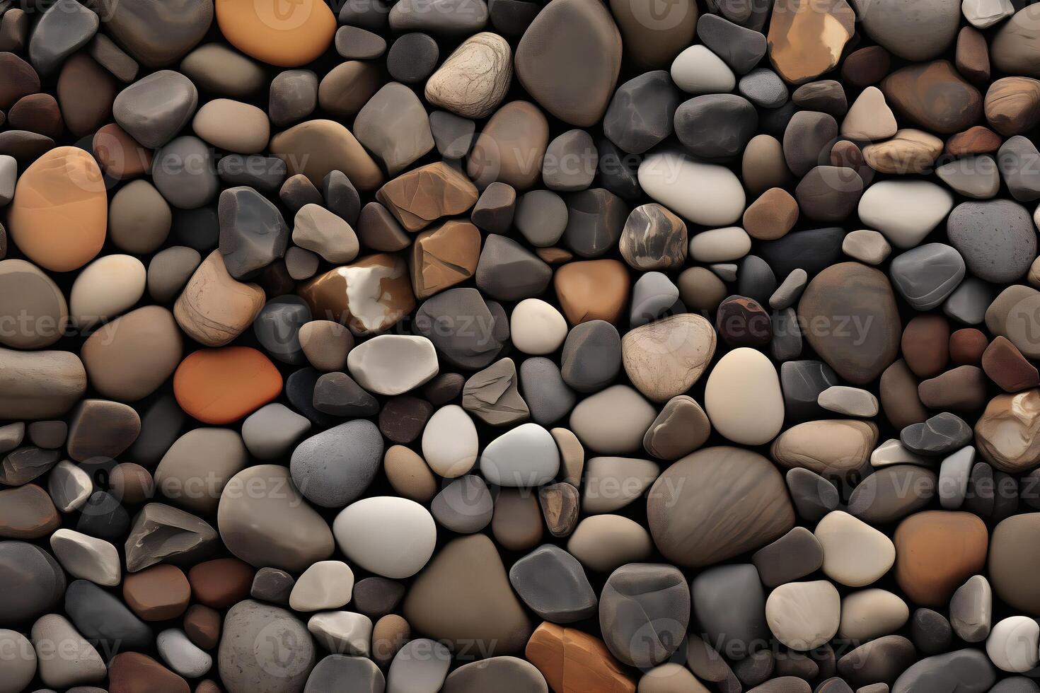 Close up of a rock wall with many different colored rocks. The rocks are of various sizes and shapes photo