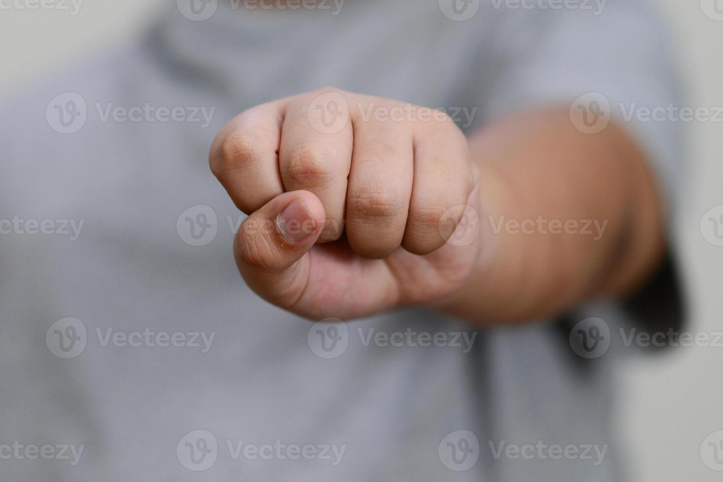 The child's hand is clenched into fist. photo