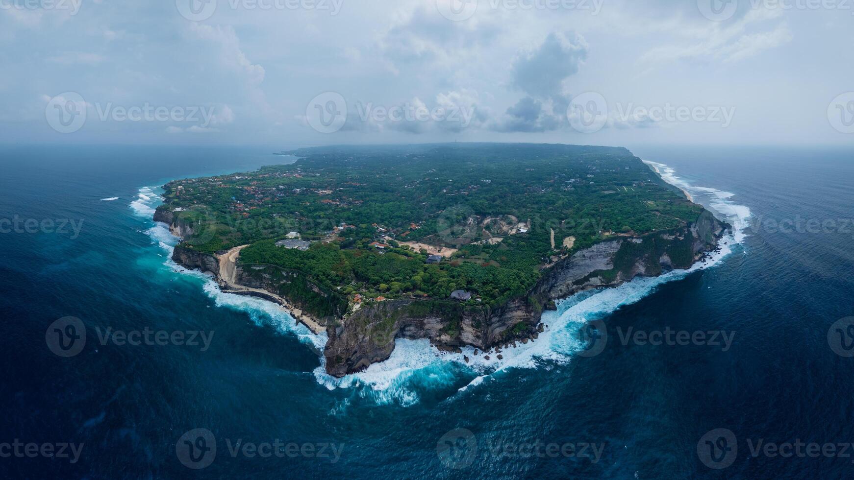 Panorama view of Uluwatu coastline with rocky cliffs, ocean with waves in Bali photo