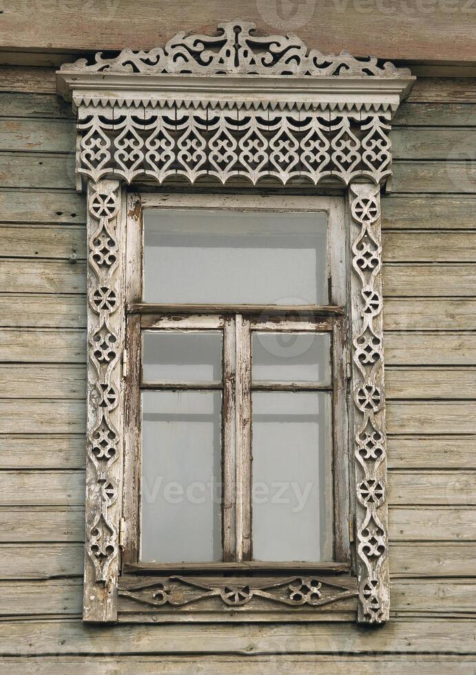 Old window of a wooden house photo