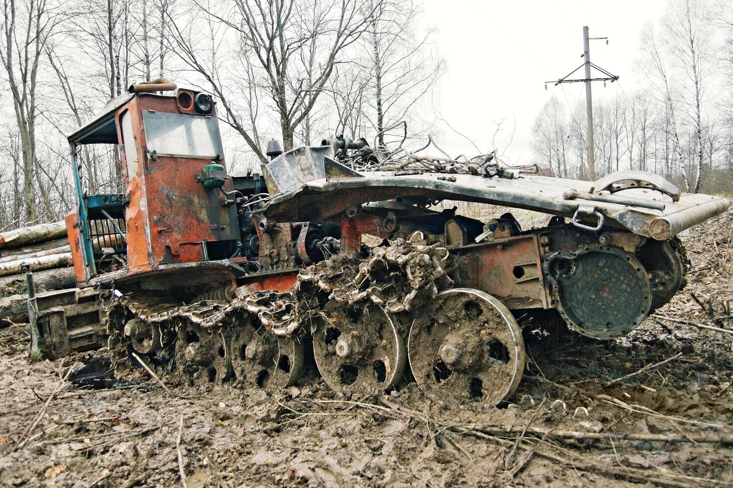 Rusty tractor in a muddy field photo