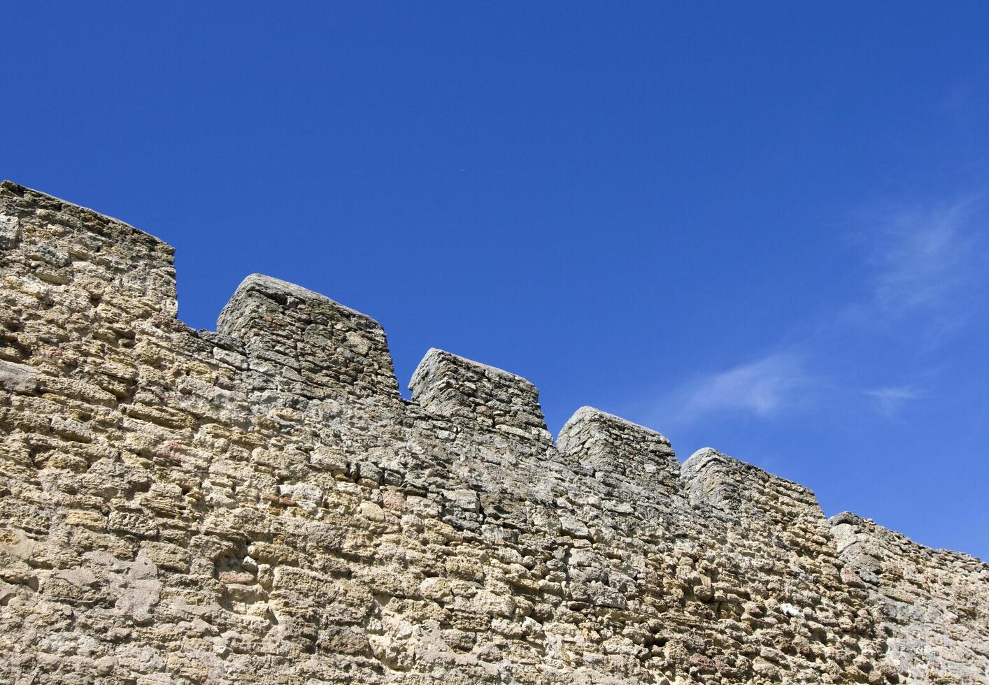 Merlons of an old fortress wall, view from below photo
