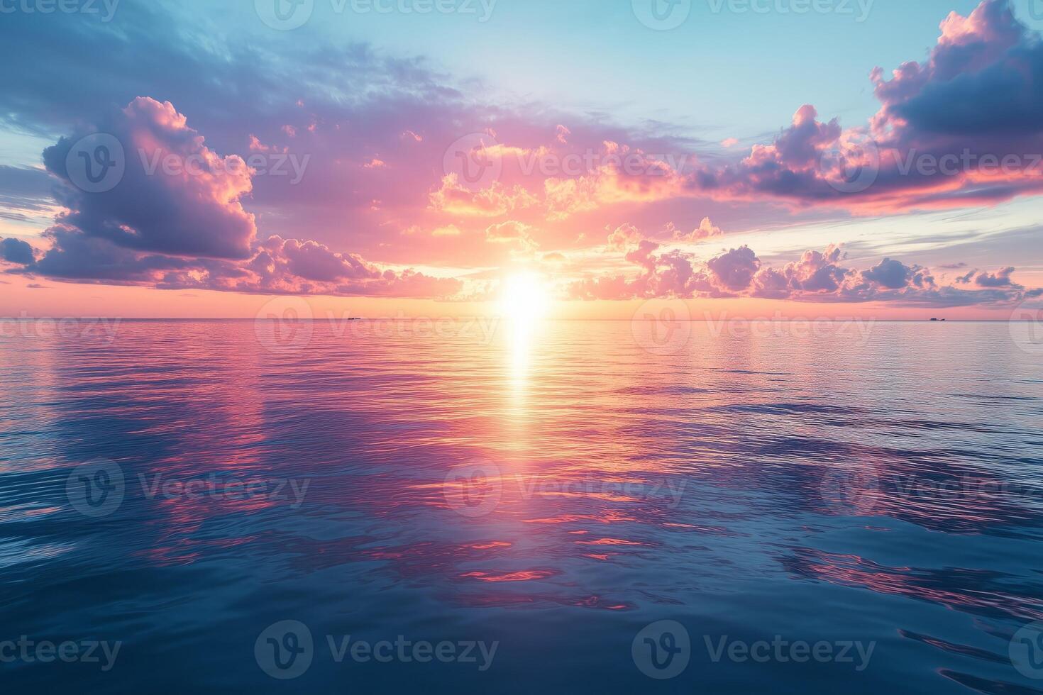 Pink and blue sunset reflecting on calm ocean with clouds photo