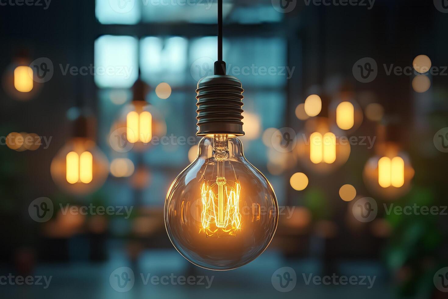 Glowing vintage light bulb hanging in a modern interior design space photo