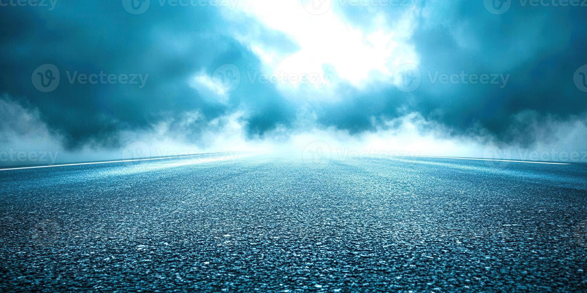 An empty road with a dark sky and clouds photo