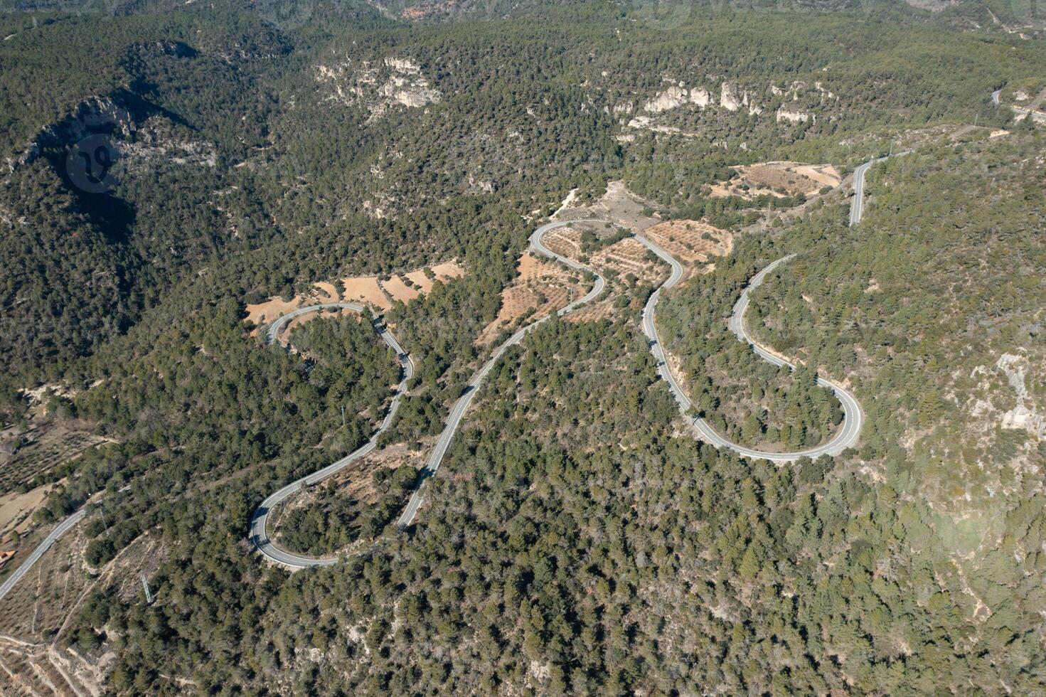 Drone view of a winding country road in Vallclara, Spain photo