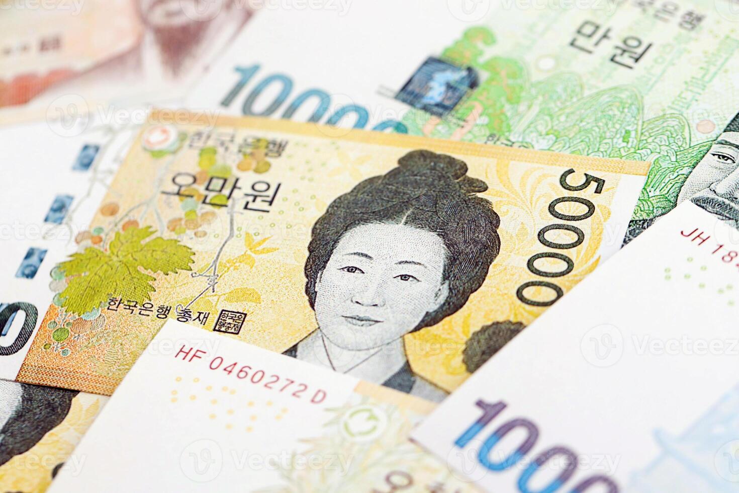 South Korean won money bills in big amount on white color table close up photo