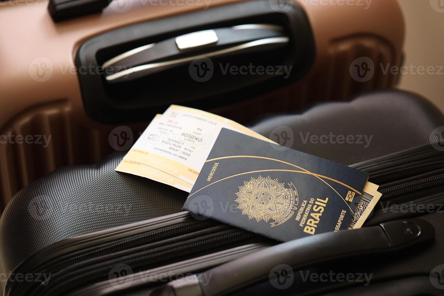 Federative Republic of Brazil passport with tickets lies on touristic suitcase in airport hall photo