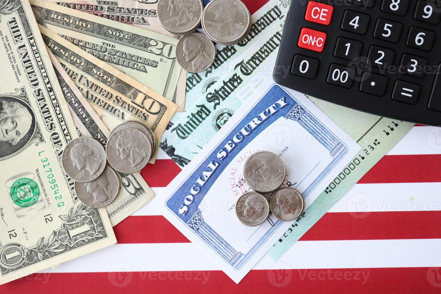 American US dollars money bills, social security number card and calculator on American flag photo
