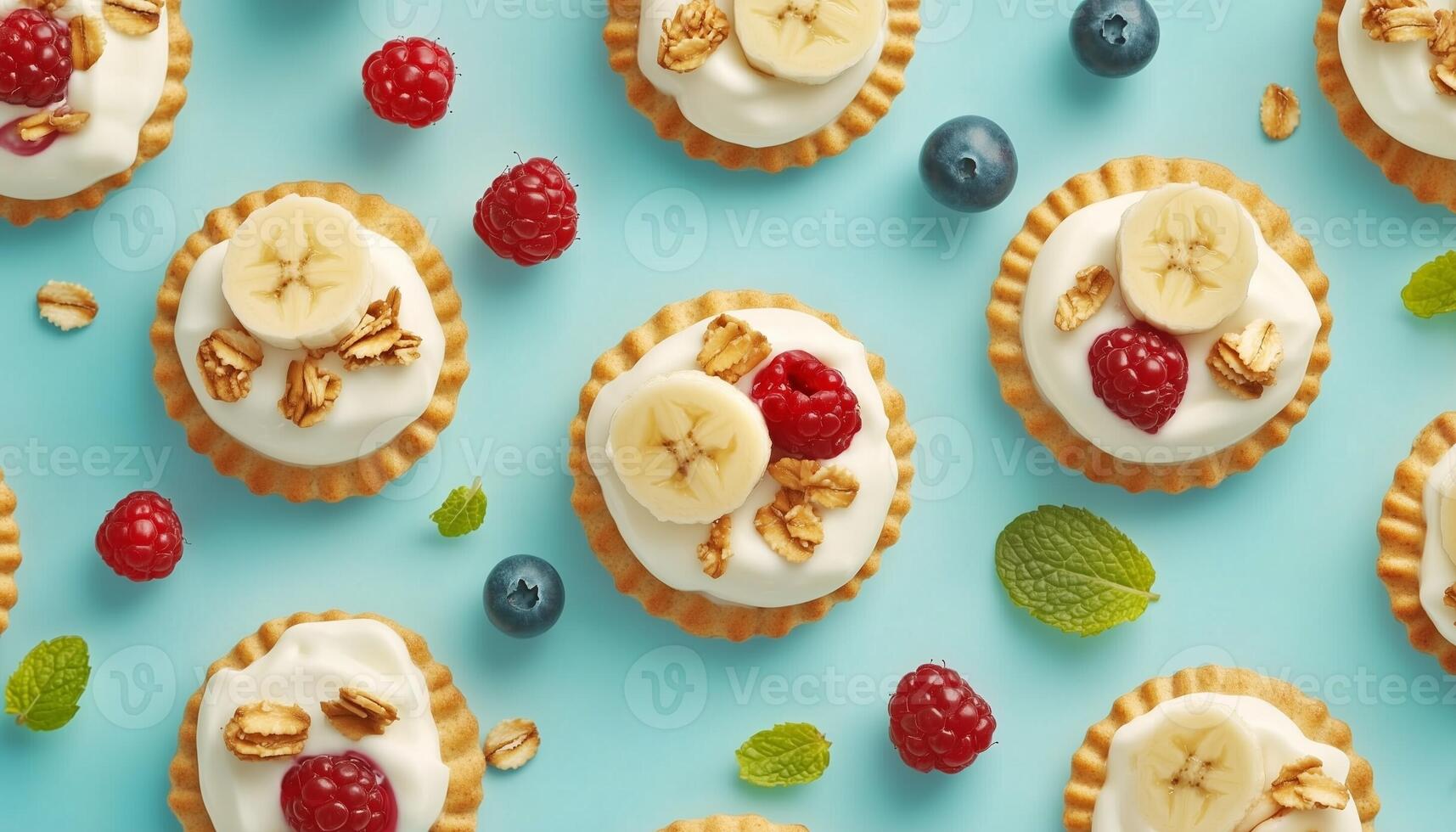 Cracker biscuit with oats, banana slice, raspberry and blueberry fruit pattern blue background photo