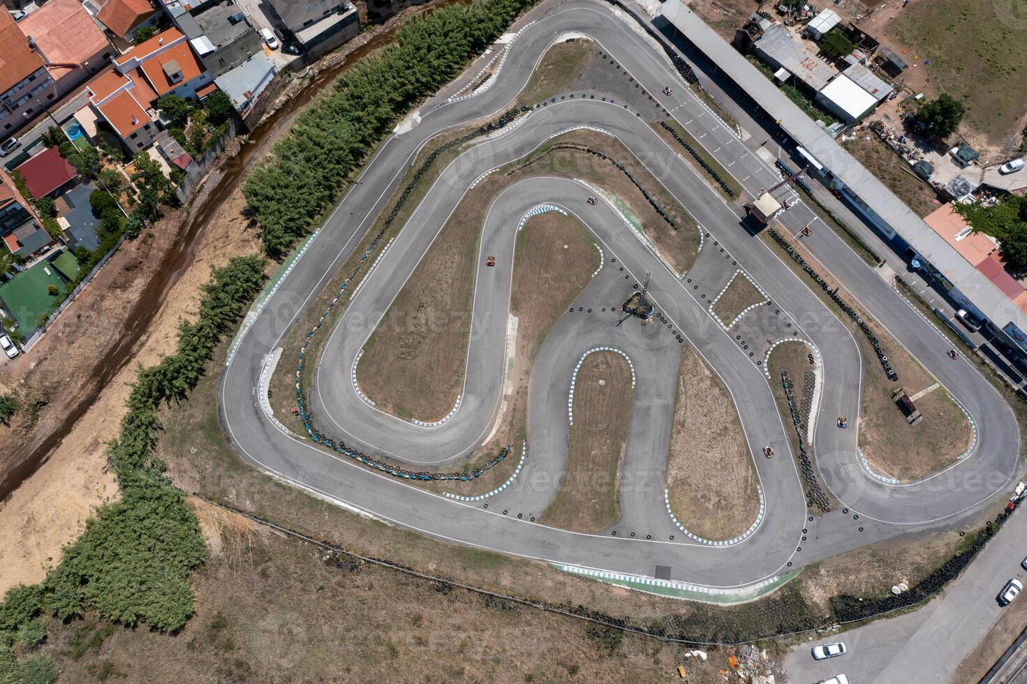 Go-karts racing on winding tracks in countryside photo