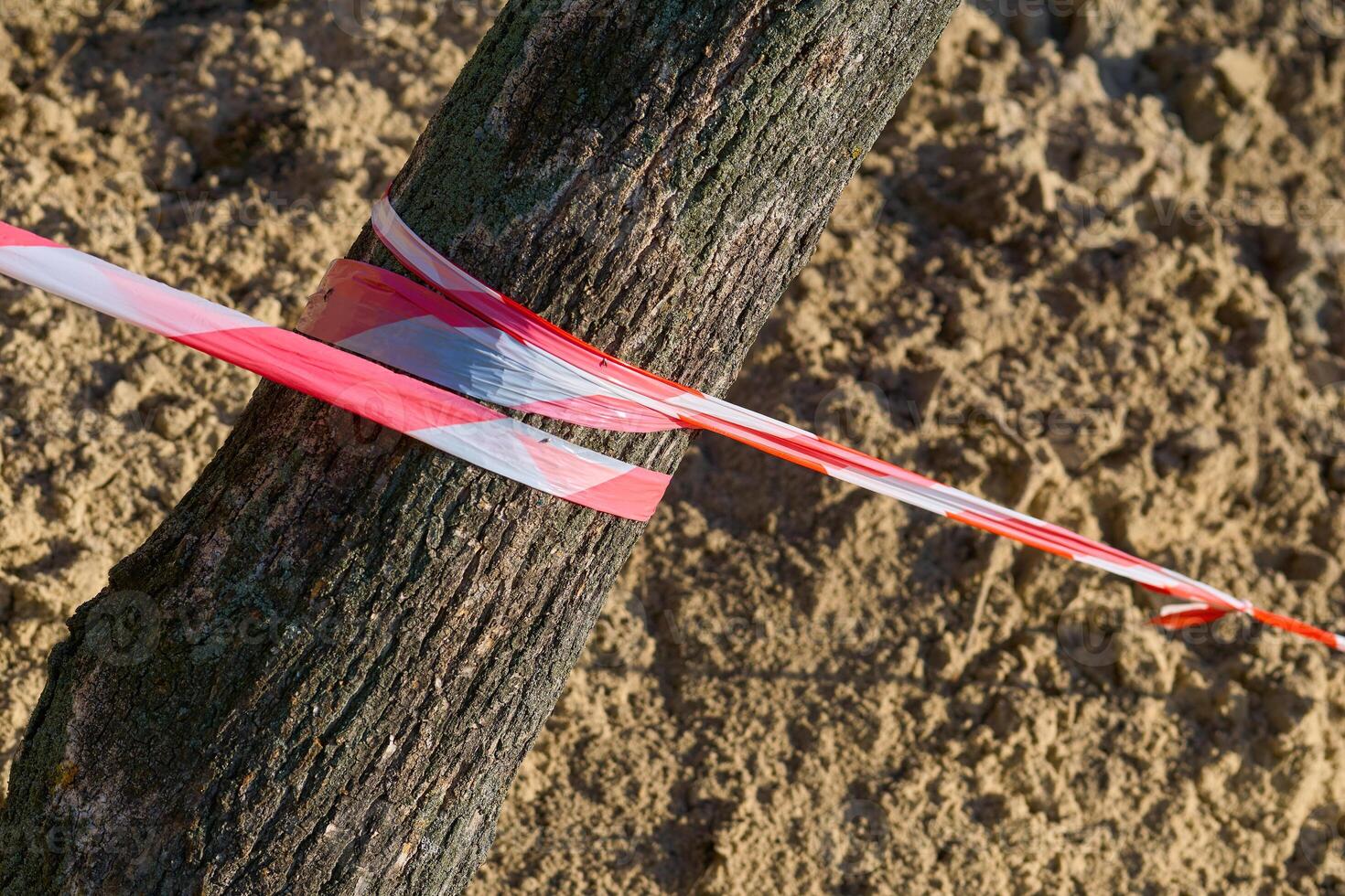 Red white fencing tape warning of danger during construction and repairs photo