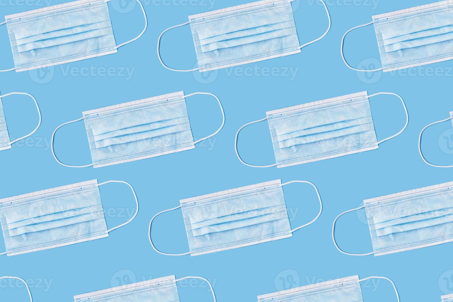 A blue background with repeated medical face masks for theme photo