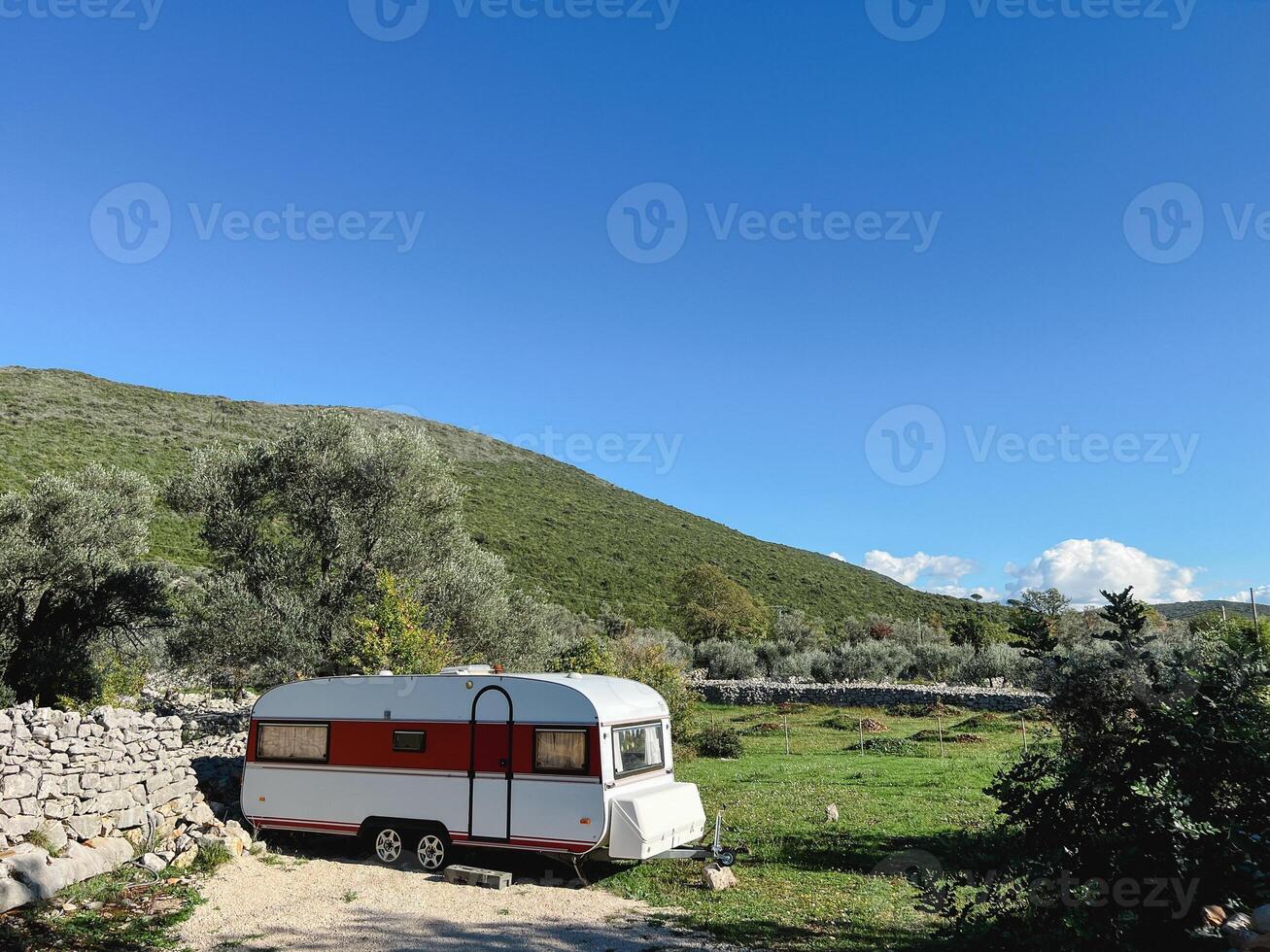 Enjoying a Vintage Caravan in a Beautiful, Serene Landscape photo