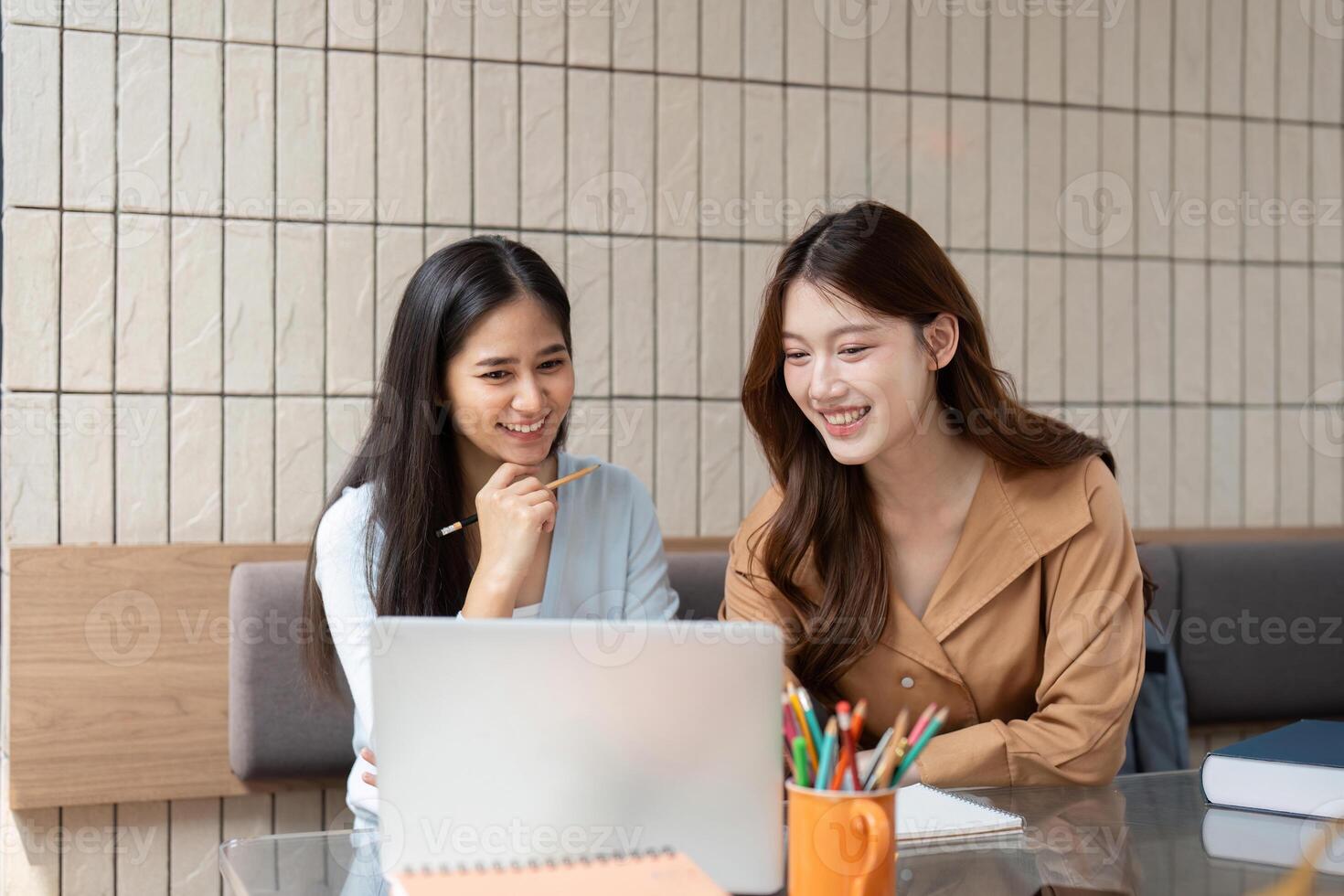 Study Break and Laughter. Two students share a light moment while collaborating on their homework. photo