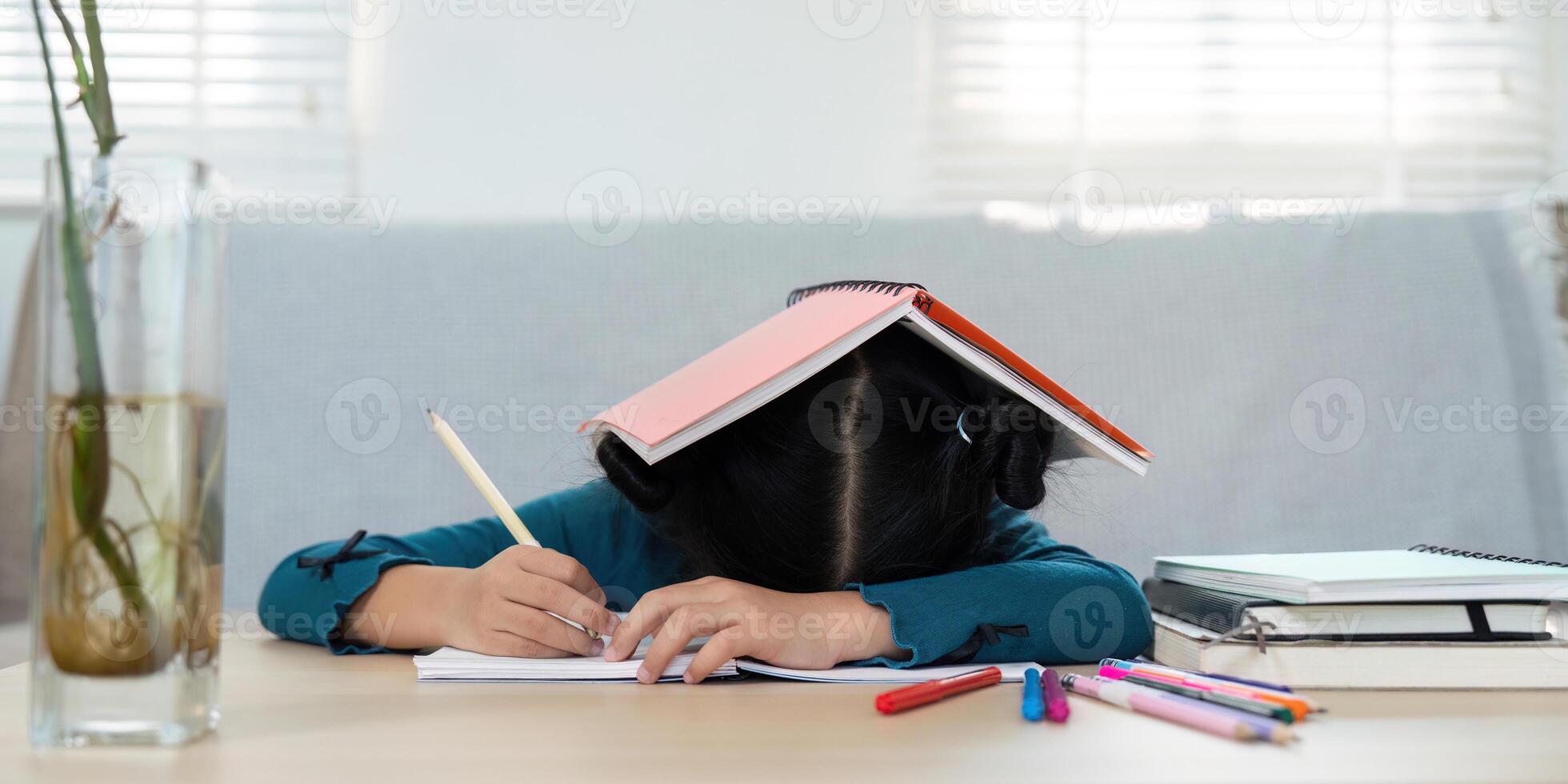 Education and Stress Management. A young girl feeling overwhelmed while studying at home. photo
