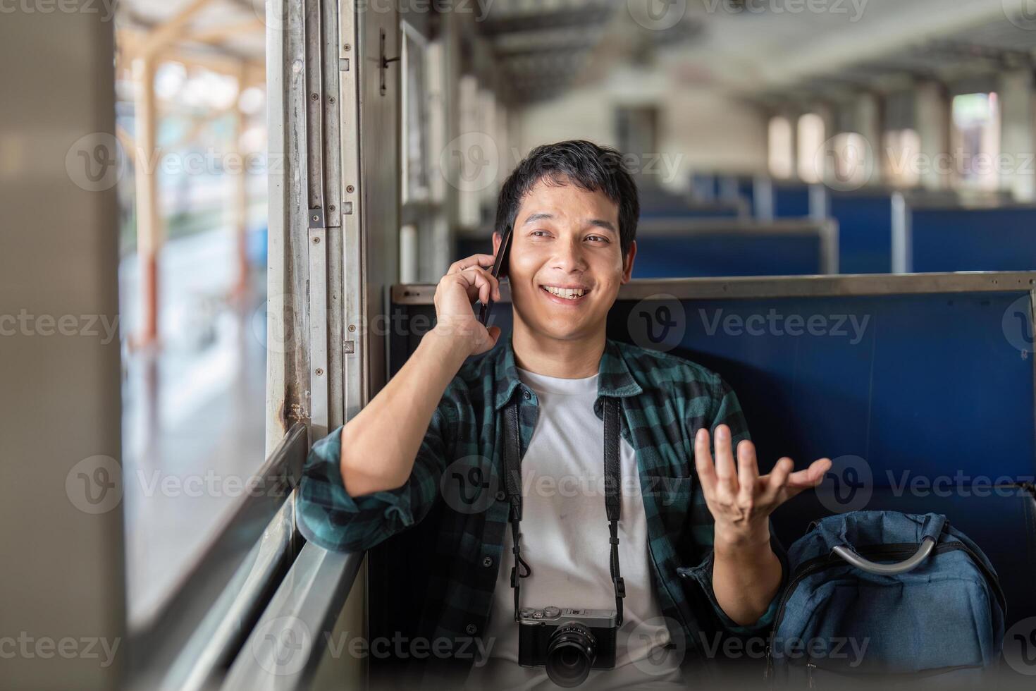 Travel and Connectivity. A young man happily chatting on the phone while embarking on a journey. photo