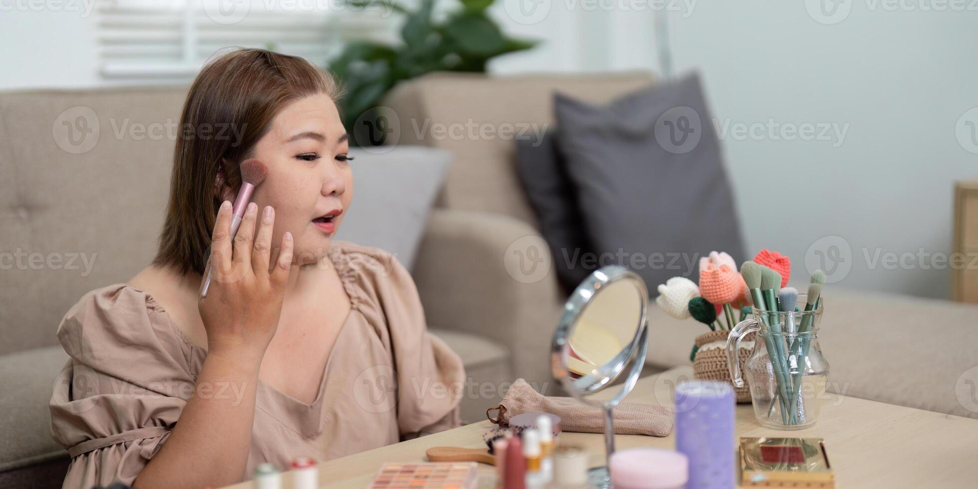 Grooming and Makeup Application. A woman expertly using brushes to enhance her features. photo