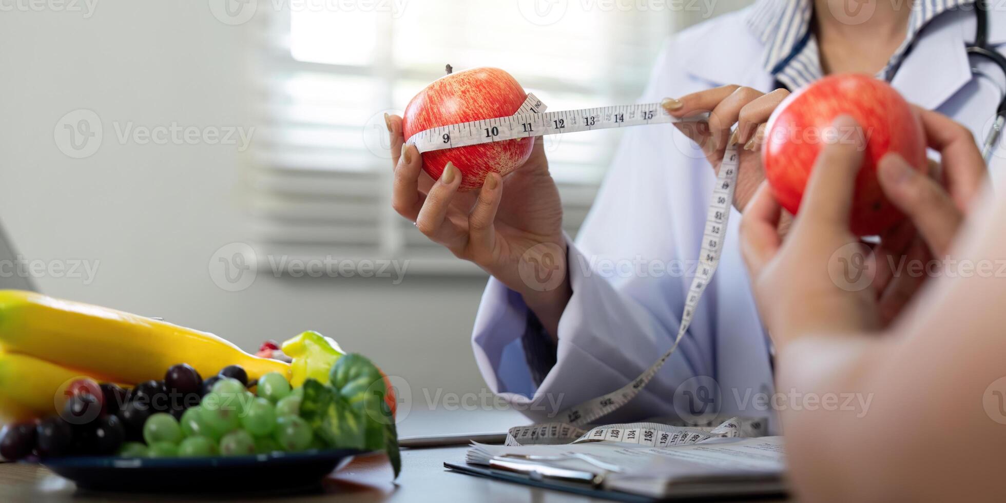 Nutrition and Wellness. A nutritionist measuring apples to explain portion control. photo
