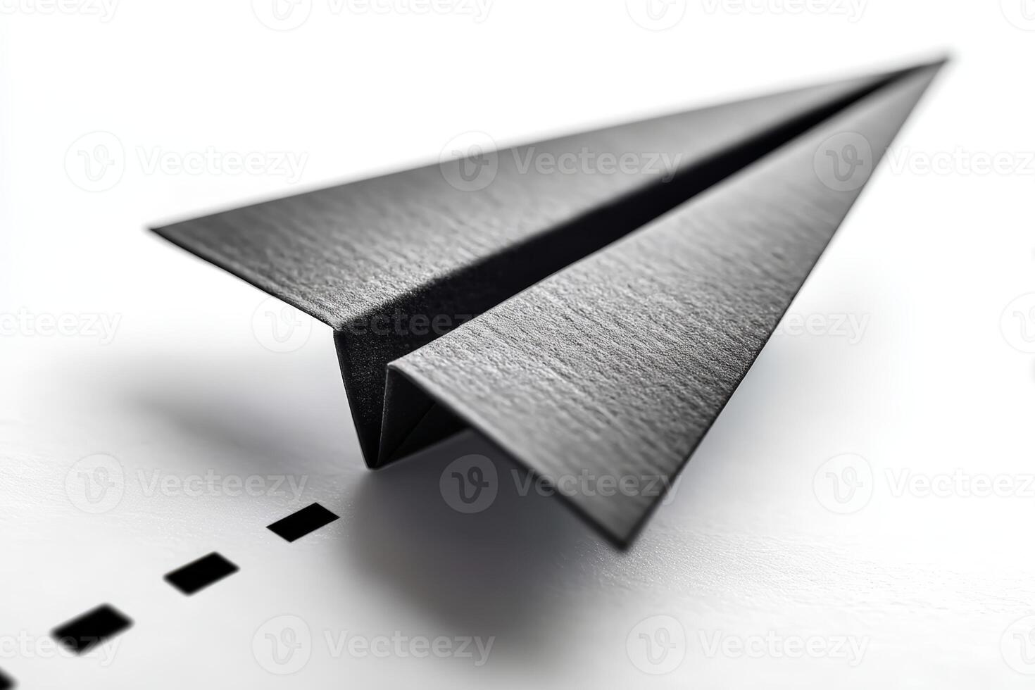Paper airplane crafted with precision on a clean surface in a well-lit space photo