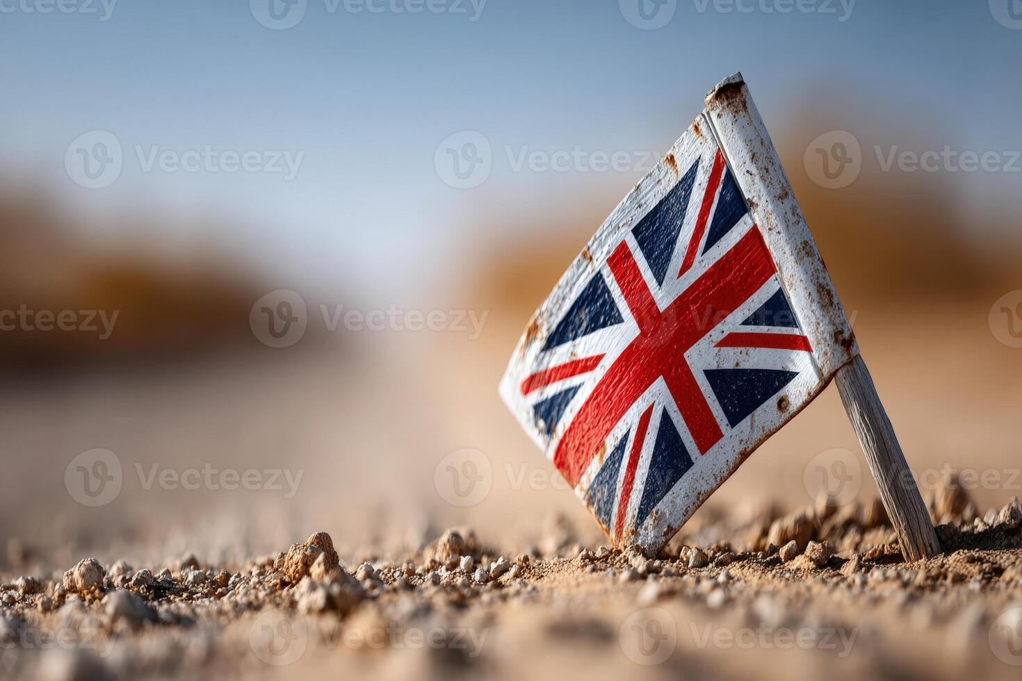 Small British flag mark in a dusty road setting during afternoon sunlight photo