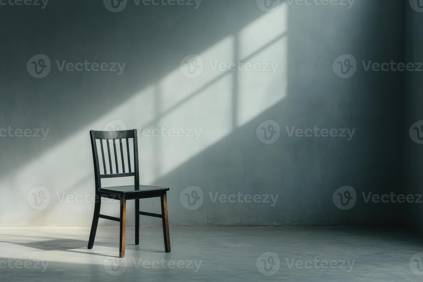 Solitary chair casts shadows in an empty room during afternoon light photo