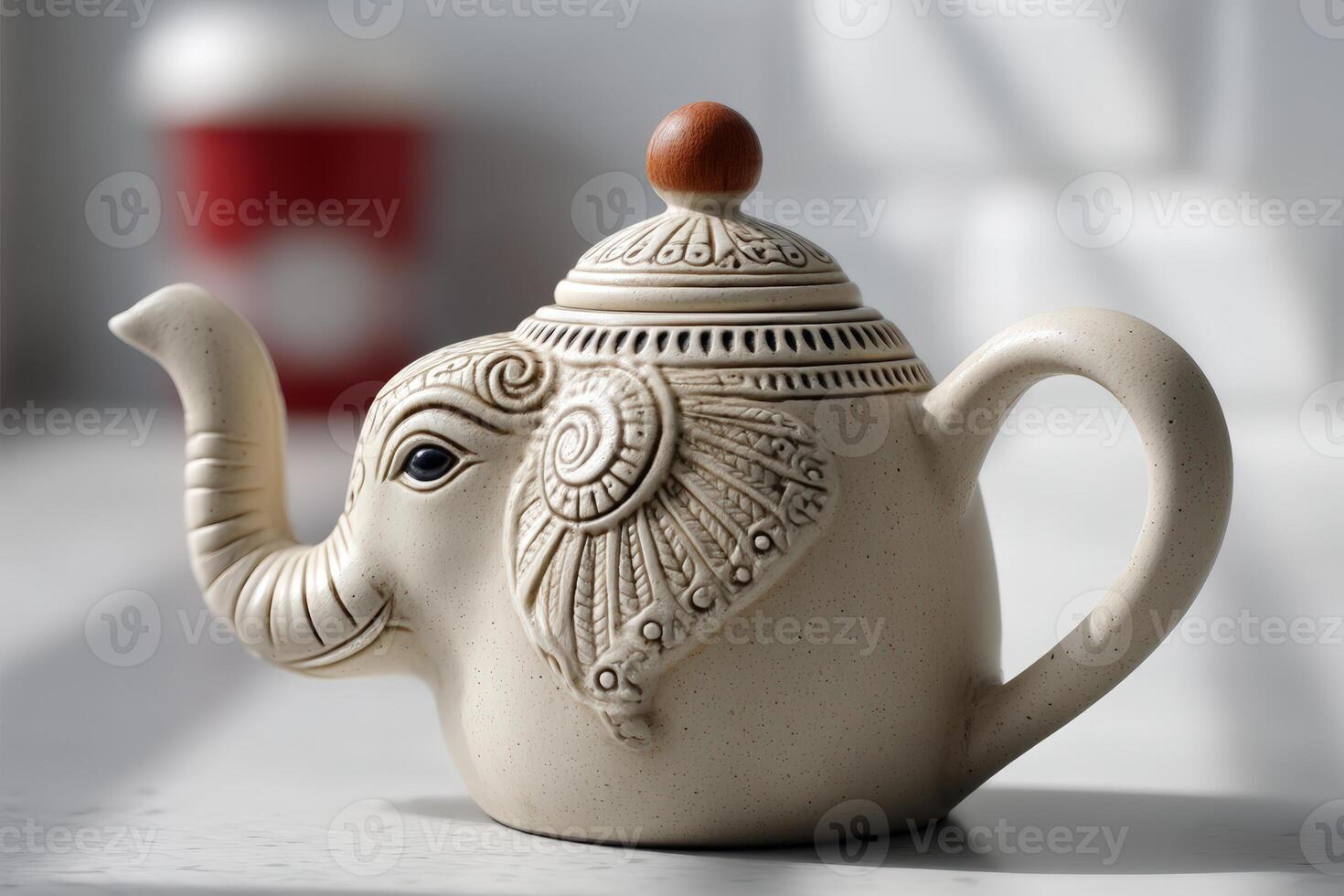 Elephant-shaped teapot rests on a table with soft light illuminating the ceramic design photo