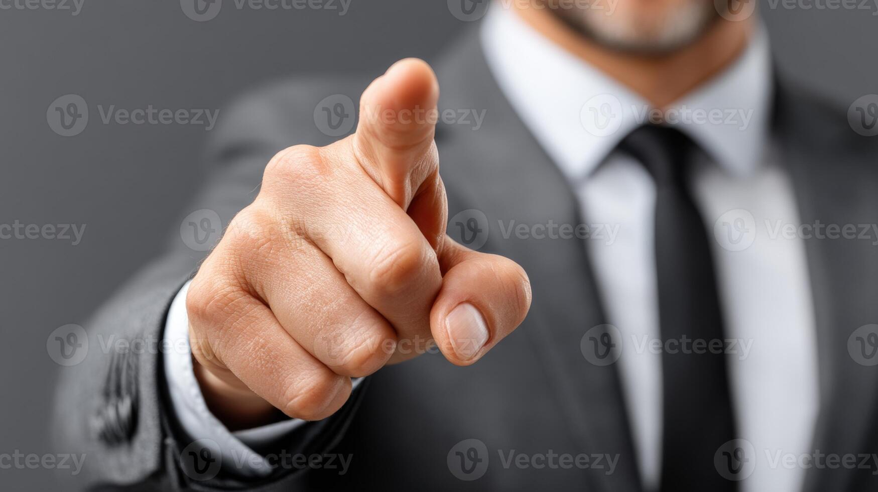 Businessman confidently pointing with a serious expression during professional meeting photo