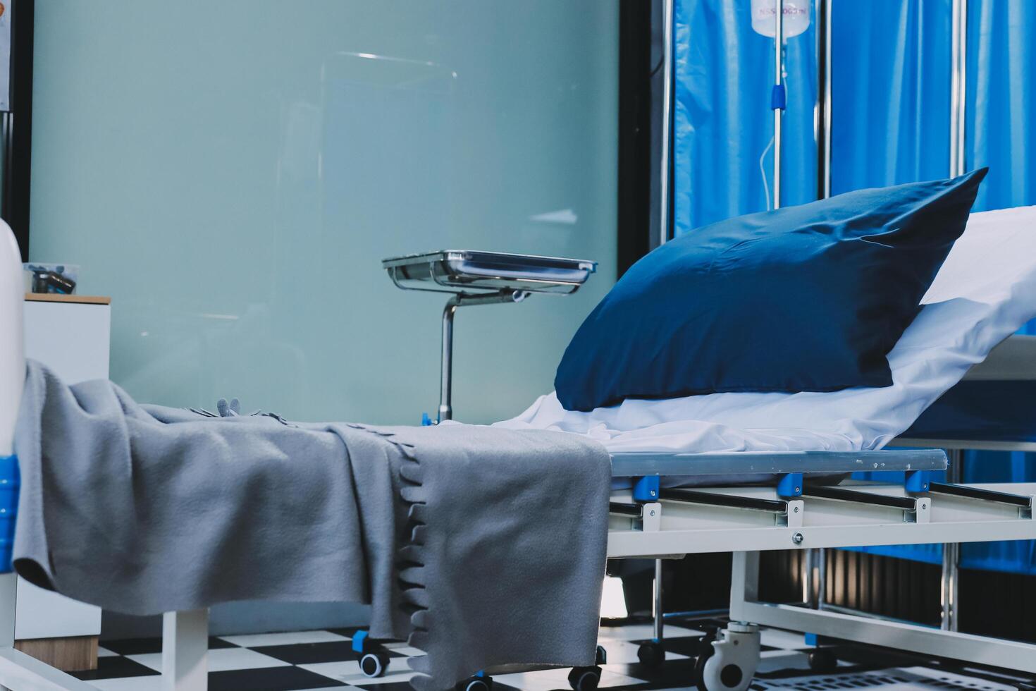A hospital bed with a blanket and pillows photo