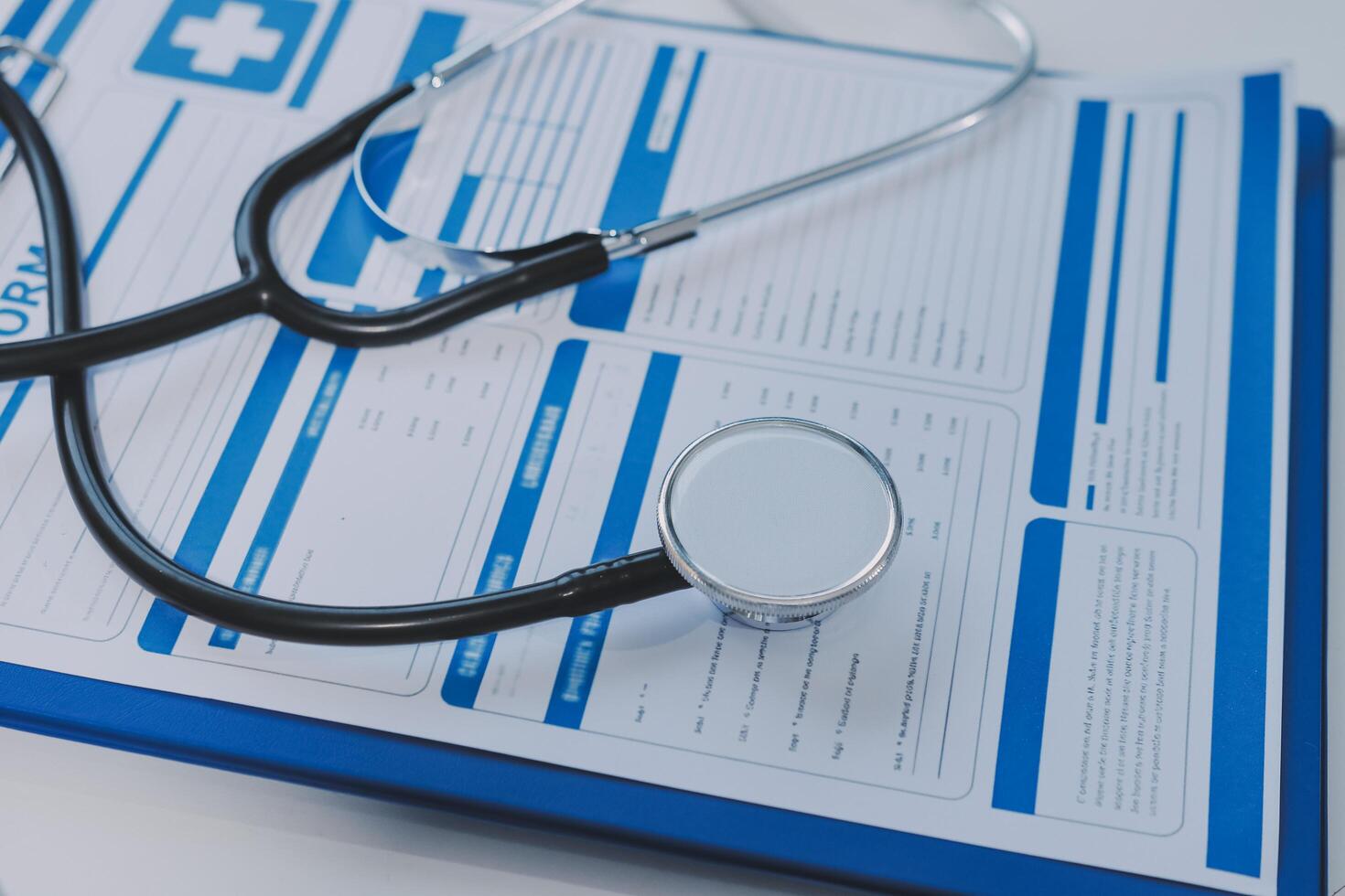 A stethoscope and medical papers on a clipboard photo